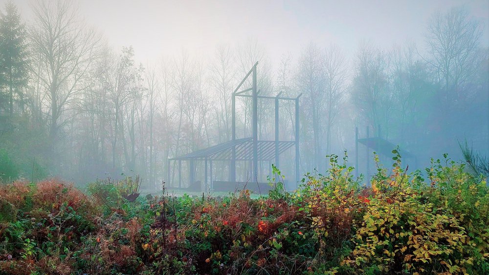 Führungen Vicus Wareswald Mitten in einer mit Nebel bedeckten Landschaft ist ein römisches Baukunstwerk zu sehen.